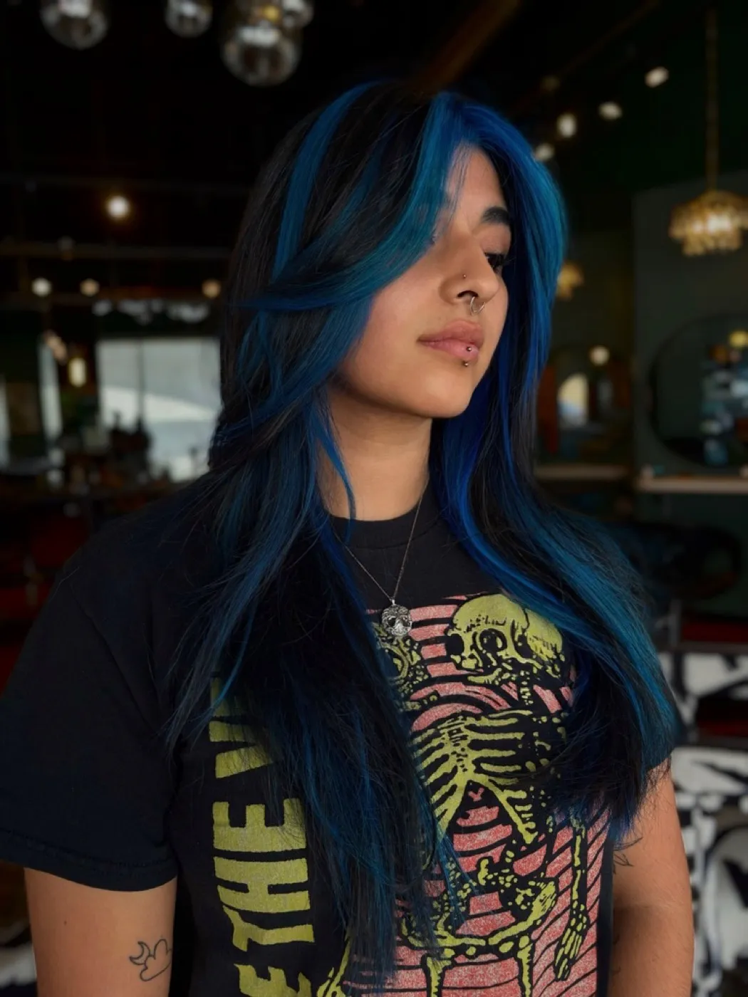 Electric blue streaks through black hair