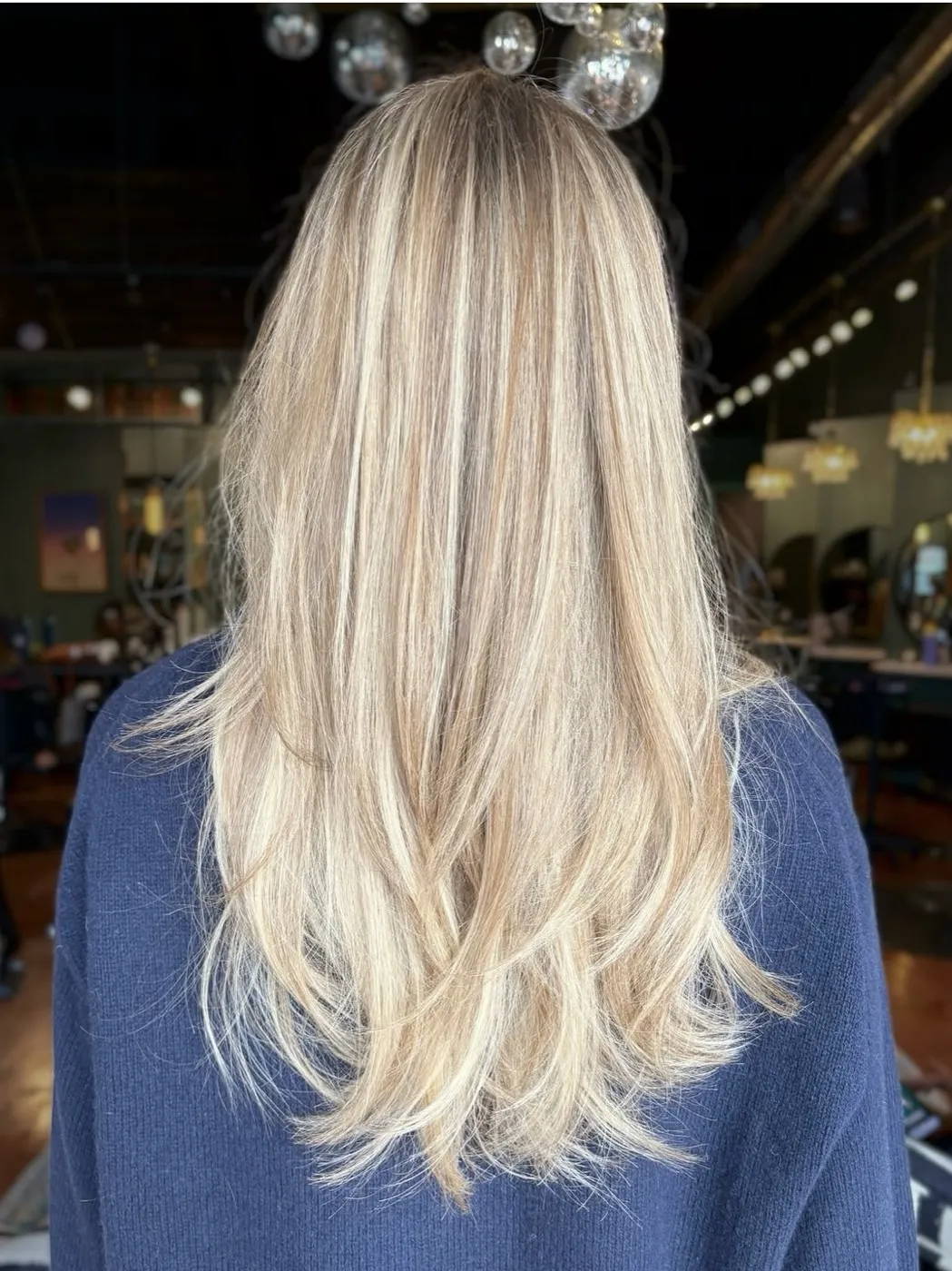 Long blonde balayage with layered ends, back view